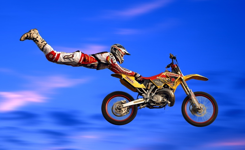 human limb, competition, yellow, dirt, sport, skill, jumping, mid-air, Jumps, Motorcycle Racing, risk, human arm, bike, blue, sky, full length, red, one person