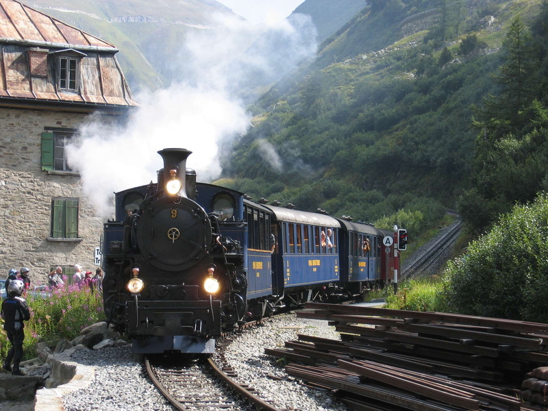 furka pass, plant, tree, historically, level crossing, public transportation, smoke, architecture, steam locomotive, summer, railroad track, alpine, train - vehicle