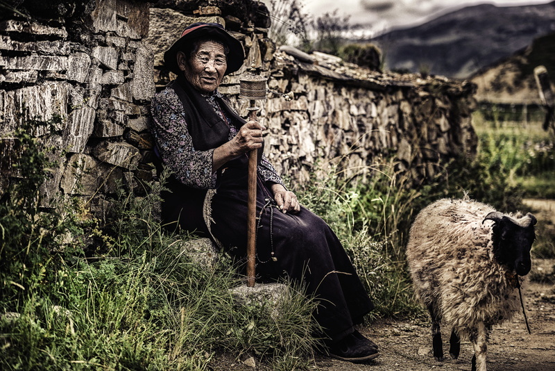 livestock, animal, pets, one person, portrait, beside, wall, facial expression, land, casual clothing, near, mountain, three quarter length, nature, farming