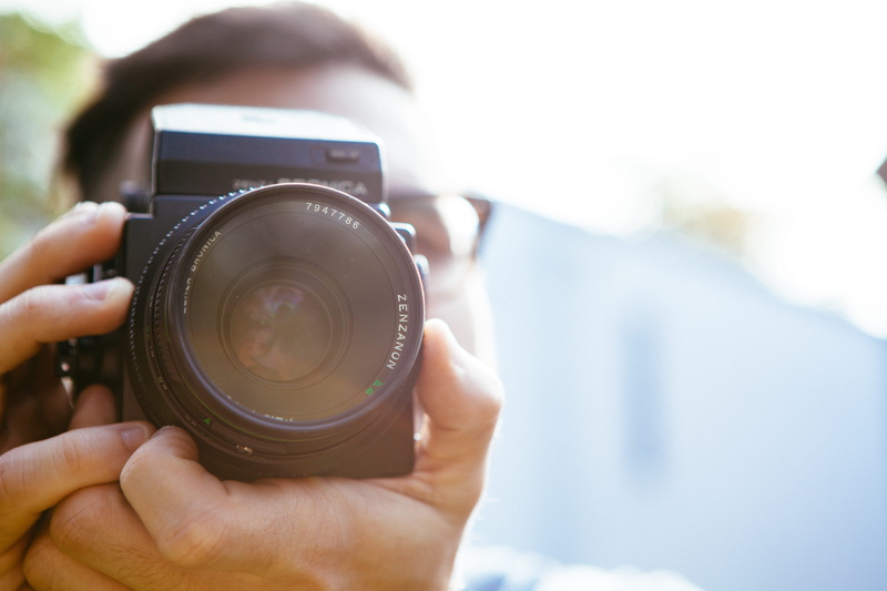 slr camera, technology, one person, photographic equipment, taking photo, human hand, young adult, 5K, bronica, outdoors, day, photographer, digital camera