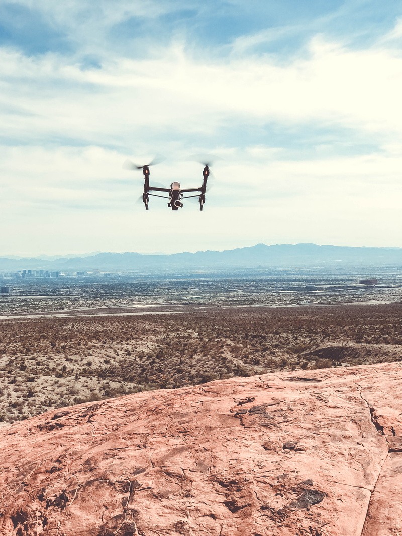 drone, sky, mountain view, shilouettes, men, mountains, one person, dji, brush, las vegas, mid-air, day, mode of transportation, landscape, flying drone