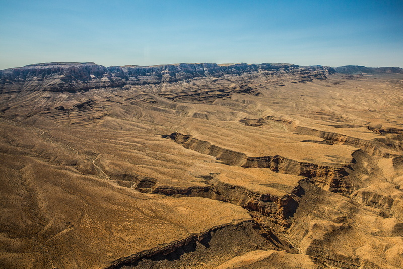 rolling landscape, bird, sky, day, landscape, ground, plateau, geology, valley, non-urban scene, physical geography, no people, nature, wilderness, high angle view