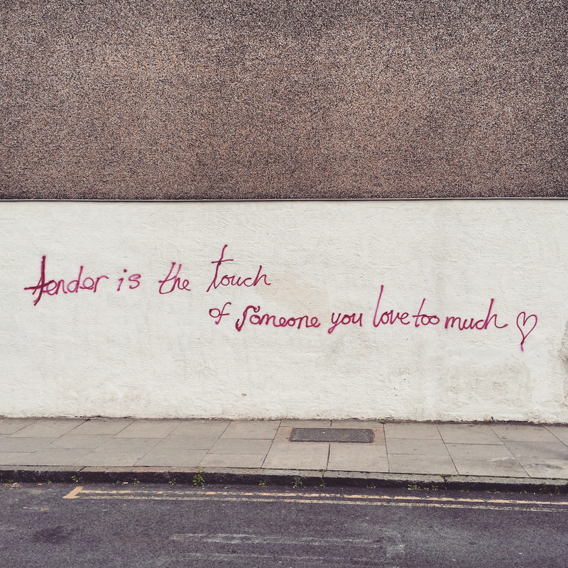 footwear, outdoors, shoe, wall, textured, footpath, day, handwriting, graffiti, pavement, wall - building feature, business card, pink color, clothing
