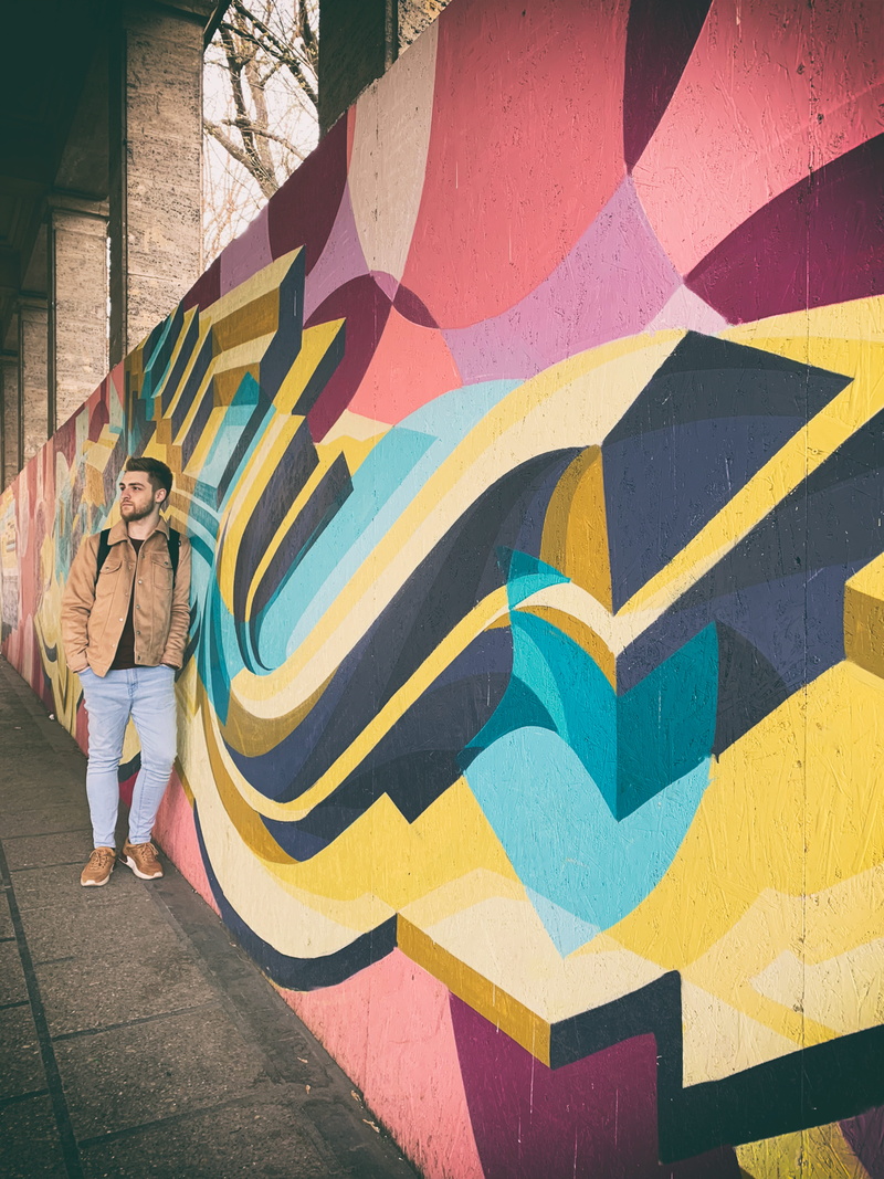 creativity, wall - building feature, aircraft, person, women, lifestyles, outdoors, art, asphalt, real people, wall, sidewalk, shorts, positive emotion