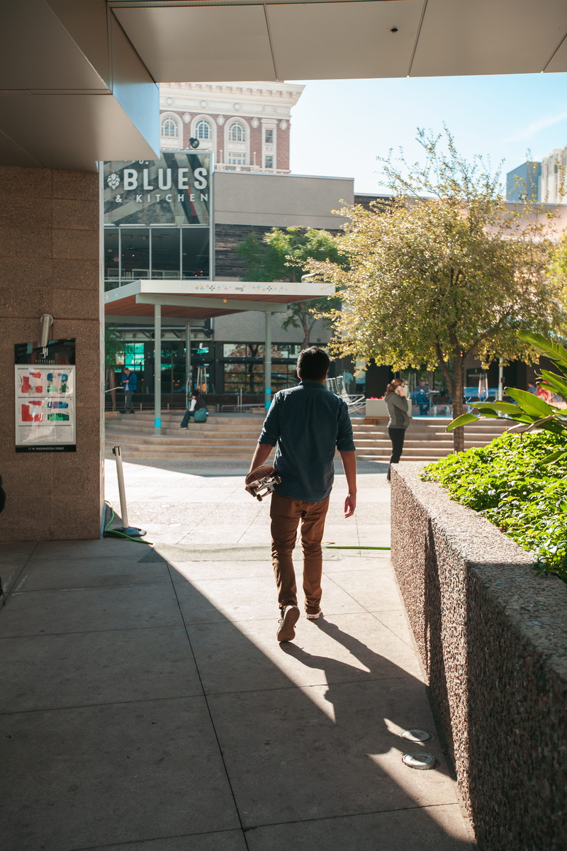 clothing, incidental people, phoenix, sunlight, phoenix, lifestyles, city, arizona, footwear, outdoors, apparel, footpath, 5K, built structure, skateboarder walking