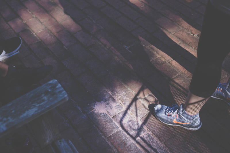 person, women, unrecognizable person, clothing, asphalt, tarmac, sidewalk, body part, running shoe, shoe, outdoors, standing, shoes, human foot, lifestyles