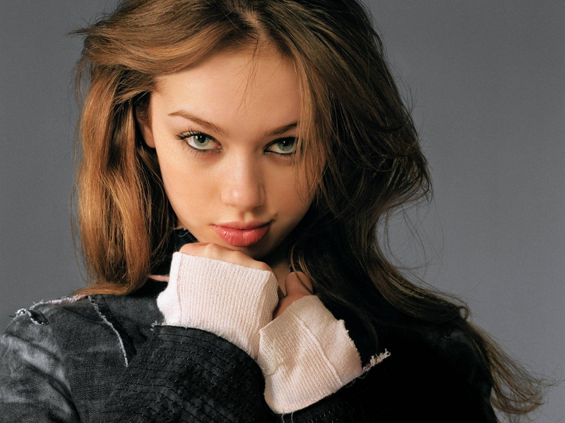 looking at camera, adult, indoors, beautiful woman, brown hair, hairstyle, long hair, portrait, headshot, one person, gray background, young adult, looking at viewer