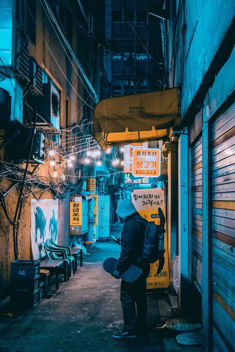 real people, south korea, full length, walking, rear view, night, market, standing, graffiti, city, furniture, outdoors, urban, hoodie, one person, building