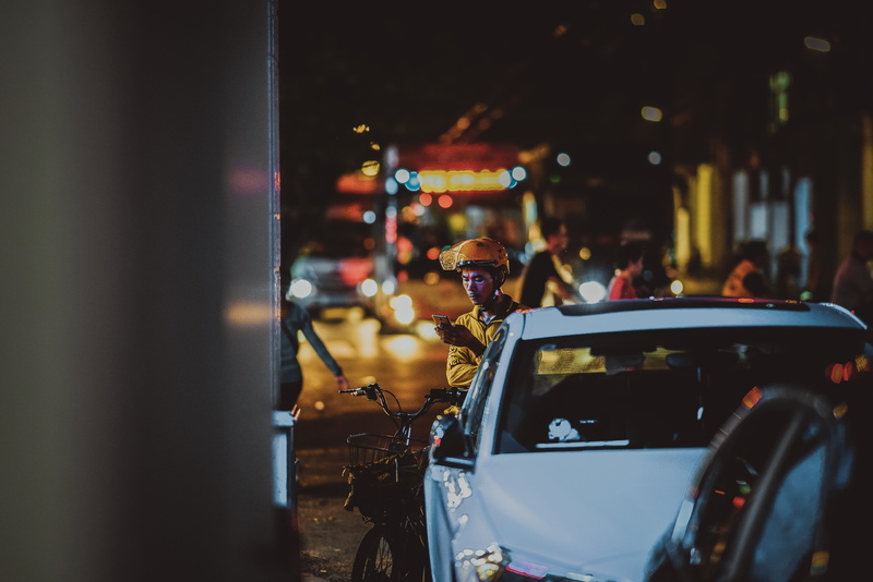 vehicle, illuminated, near, lifestyles, yellow, man, person, apparel, men, helmet, street, outdoors, people, motor vehicle, photography, selective focus
