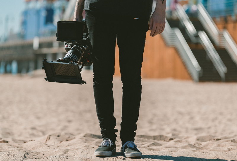 video camera, guy, adult, leg, casual clothing, nature, black, camera, lifestyles, leisure activity, human limb, holding, camcorder, sand, equipment, person
