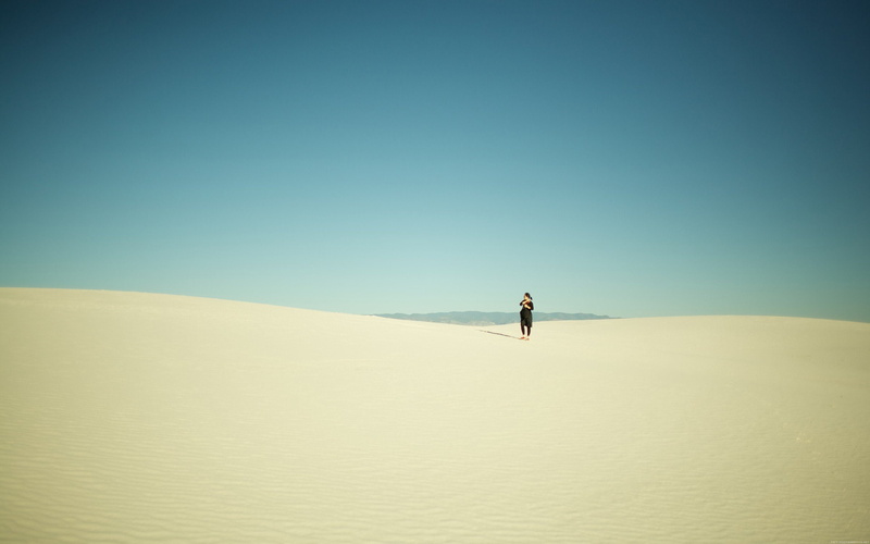 solitude, scenics - nature, clear sky, tranquil scene, desert, one person, outdoors, 2K, day, sand, remote, land, sky, environment, climate, landscape