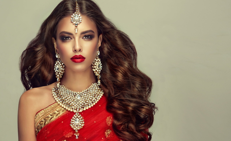 hairstyle, makeup, portrait, 2K, beauty, look, earrings, brown hair, decoration, necklace, curls, background, in red