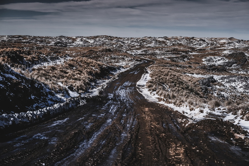 cloud - sky, tranquil scene, land, nature, outdoors, beauty in nature, snow, day, no people, mountain, dirt road, cold temperature, non-urban scene, mud