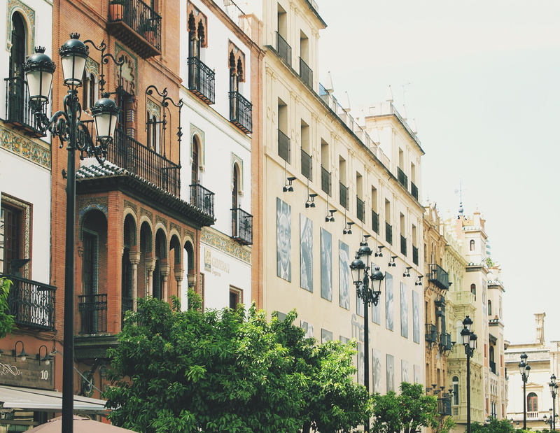 building, city, residential district, clear sky, lamp posts, plant, apartment, no people, buildings, street, built structure, day, tree, urban, spain, building exterior