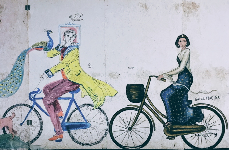 lifestyles, clothing, art and craft, men, women, wall - building feature, transportation, mode of transport, full length, creativity, land vehicle, sitting