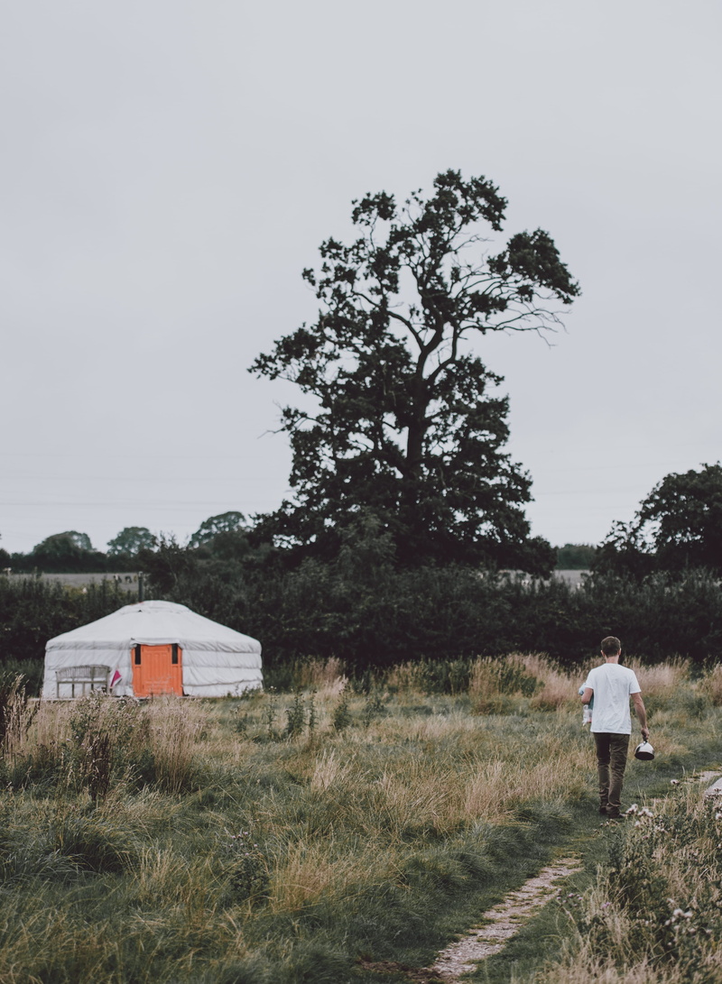 day, nature, casual clothing, non-urban scene, full length, one person, tent, walking, 4K, sky, lifestyles, pathway, rear view, yurt, yurts, standing