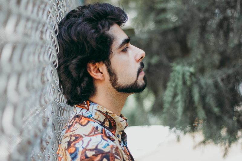 wearing, profile view, handsome, man, collar, adult, buttons, trees, headshot, shirt, chain link fence, hipster - person, hairstyle, serious, contemplation
