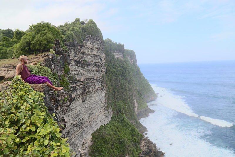 casual clothing, ocean, indonesia, sea, land, explore, 5K, one person, uluwatu temple, outdoors, rock, water, beach, day, horizon over water, cliff, women