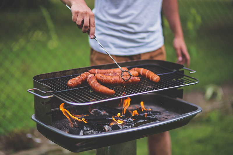 real people, day, grilling, sausages, one person, food and drink, human hand, holding, freshness, charcoal, barbecue grill, bbq, outdoors, boy, heat, standing