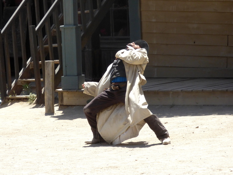 obscured face, wounded, day, nature, built structure, falling, shot, people, hollywood, costume, city, outdoors, real people, wood - material, wild west