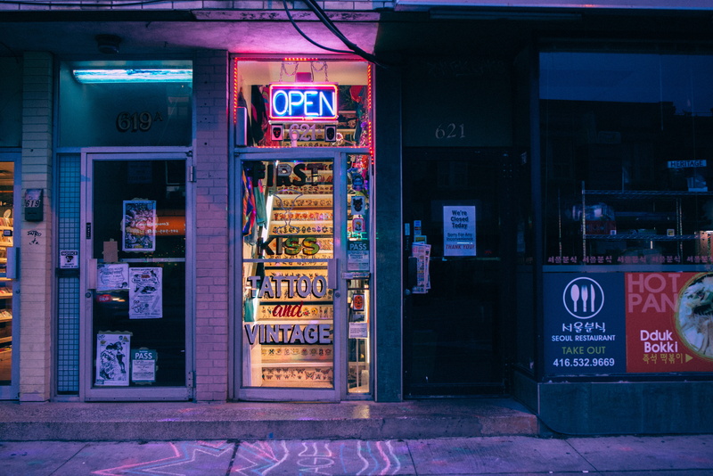 sidewalk, text, no people, lights, the annex, open, tattoo shop, door, retail display, retail, communication, food, vending machine, western script, choice