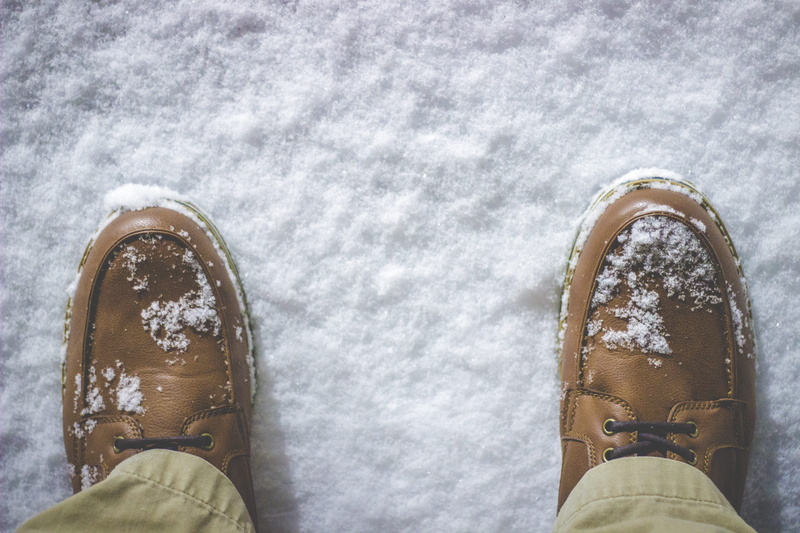 shoe, clothing, person, lace-up, view, ground, low section, leisure activity, brown, day, body part, winter, human Foot, snow, outdoors, real people, feet