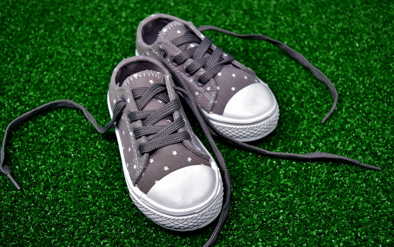 outdoors, lace - fastener, personal accessory, pair, white color, plant, sports shoes, childrens shoes, sneaker, compatibility, small, youth, absence, high angle view