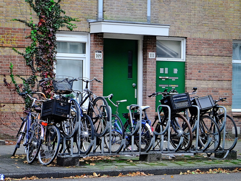 land vehicle, stationary, window, mode of transportation, parking, architecture, no people, outdoors, cool, collection, building exterior, wall, city, bycicles