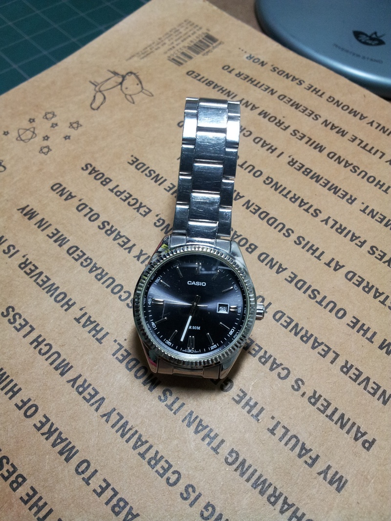 western script, close-up, law, no people, accuracy, casio watch, watch, publication, indoors, watches, table, clock, number, communication, book, high angle view