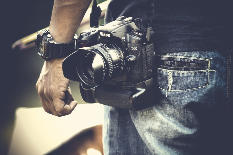 human hand, casual clothing, human limb, casio, midsection, leisure activity, one man only, jeans, camera - photographic equipment, real people, lifestyles