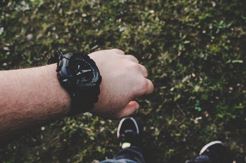 casio, human hand, gshock, lifestyles, plant, day, land, black, checking the time, human limb, arm, vegetation, focus on foreground, grass, caucasian, wearing