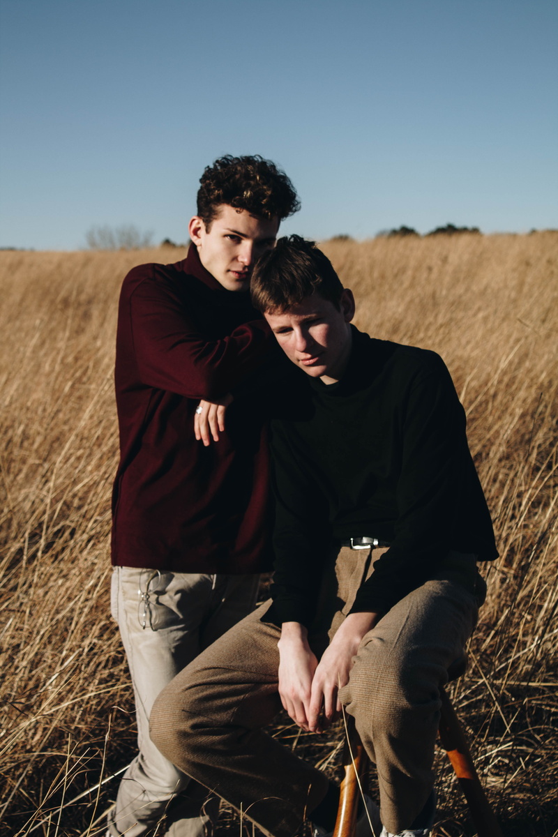 outdoors, nature, fashion, grassfield, real people, male, young men, middle, casual clothing, togetherness, field, three quarter length, front view, leaning