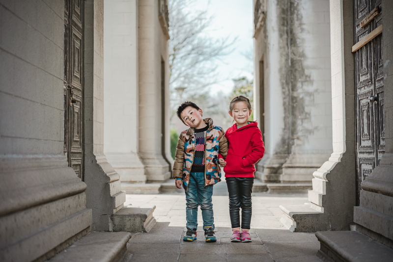 standing, happiness, outdoors, narrow, shoe, human, smiling, architecture, child, apparel, emotion, childhood, warm clothing, path, family, boys, pants