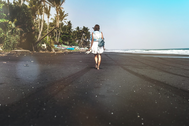 vacation, rear view, sunlight, sand, day, water, black, adult, clear sky, lifestyles, beach, young adult, barefoot, walking, sea, real people, landscape