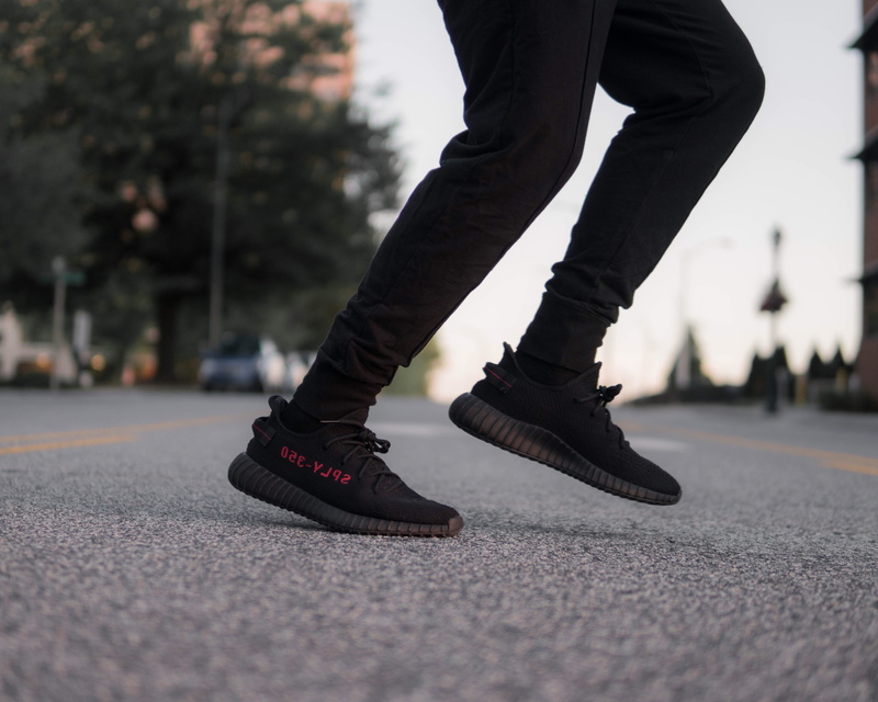 wearing, adidas, city, selective focus, surface level, sneakers, shoe, v, lifestyles, real people, human limb, low section, yeezy, black, 4K, sport, human body part