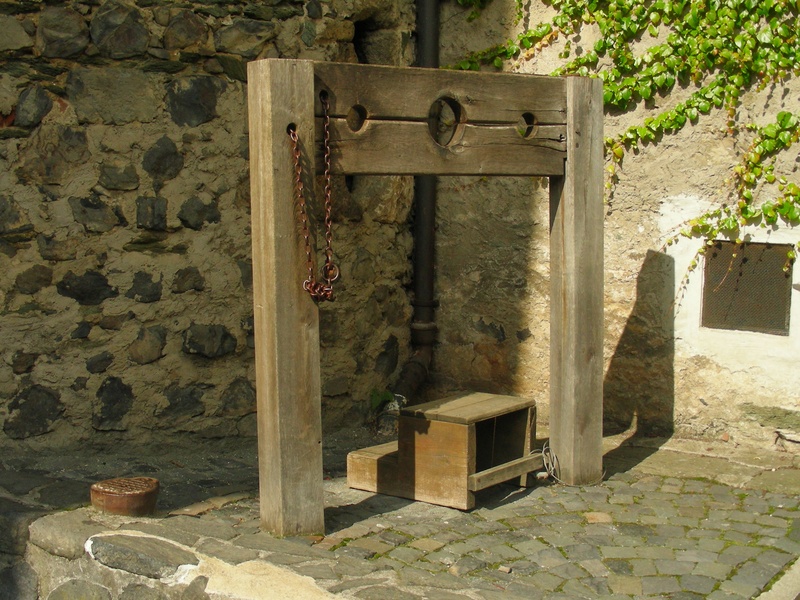 stone material, outdoors, architecture, peg, stone wall, sunlight, pillory, history, middle ages, wall - building feature, nature, no people, building