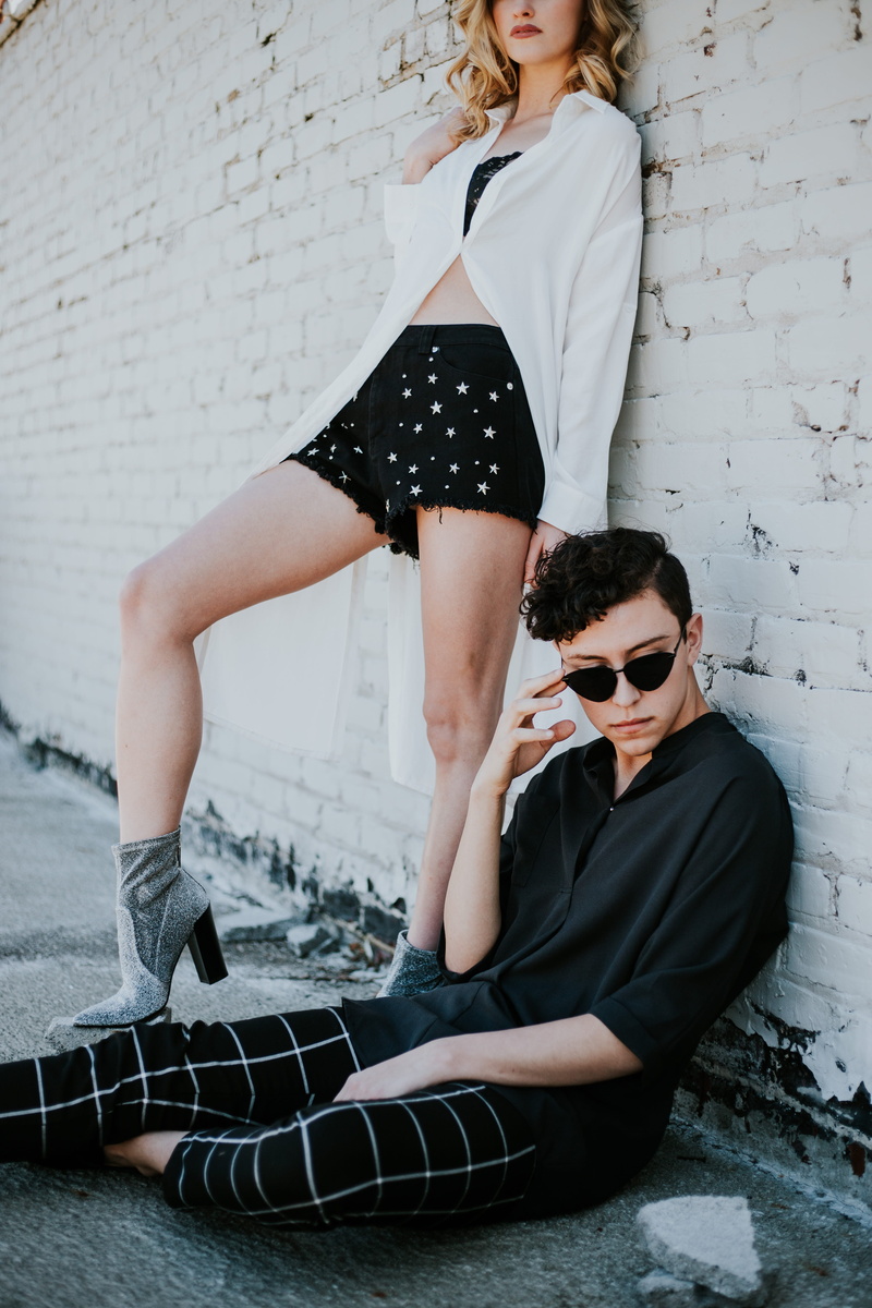 wall, women, fashion, photography, star, leisure activity, clothing, white, casual clothing, full length, caucasian, sitting, brick, city, woman, street