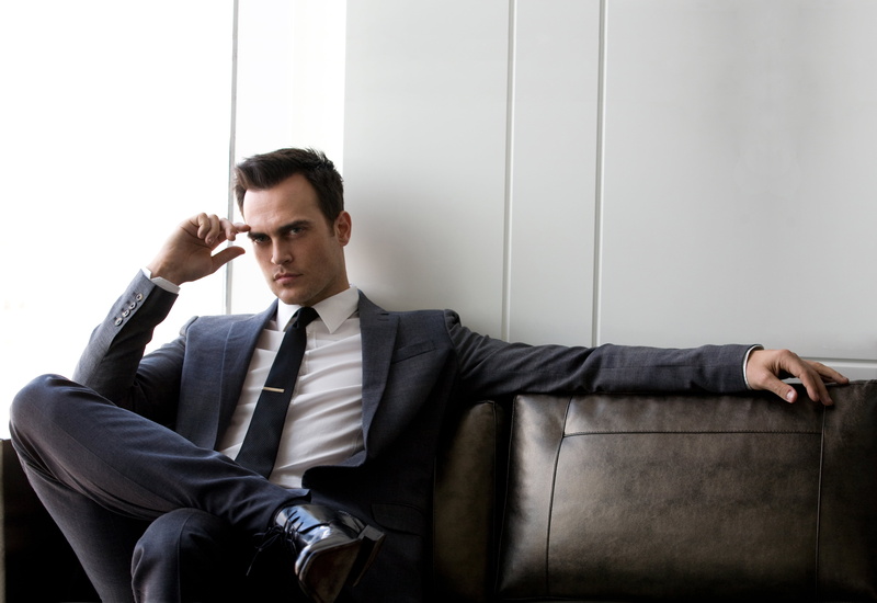 indoors, only Men, one Person, looking, coat, cheyenne jackson, formalwear, businessman, sitting, success, contemplation, modern, blue, serious, adults Only