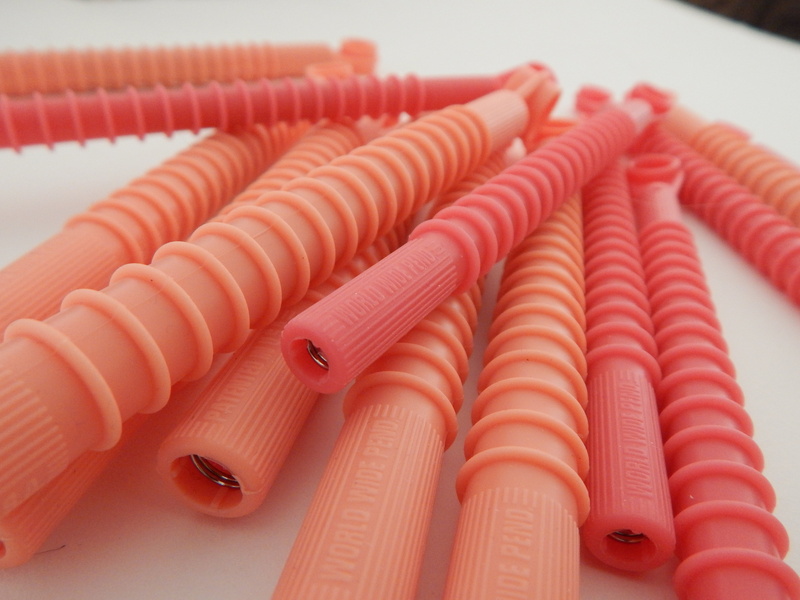 large group of objects, hair curlers, roller, wavy, focus on foreground, pink, spiral, curlers, set, rollers, indoors, curler, hairstylist, equipment, curling