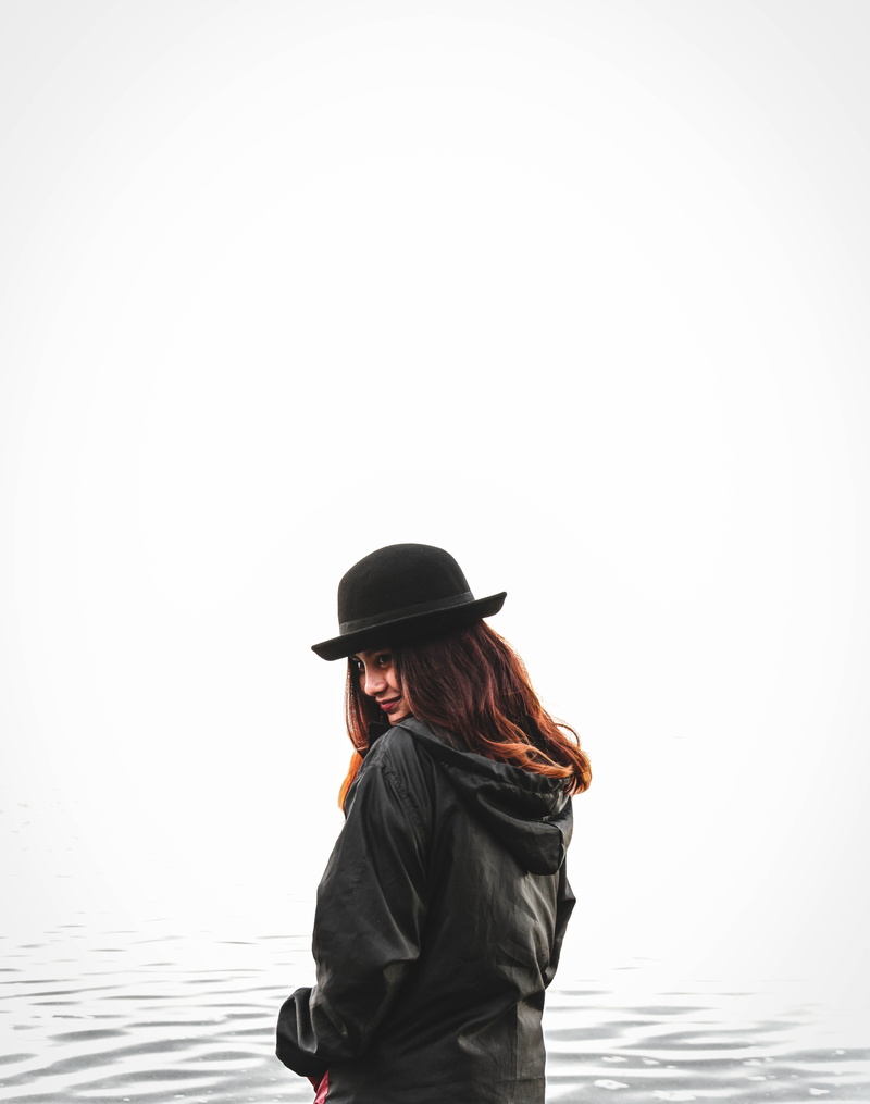 sky, waist up, water, 5K, copy space, outdoors, one person, sea, hat, nature, white addict, lake, hairstyle, warm clothing, west, casual clothing, clear sky