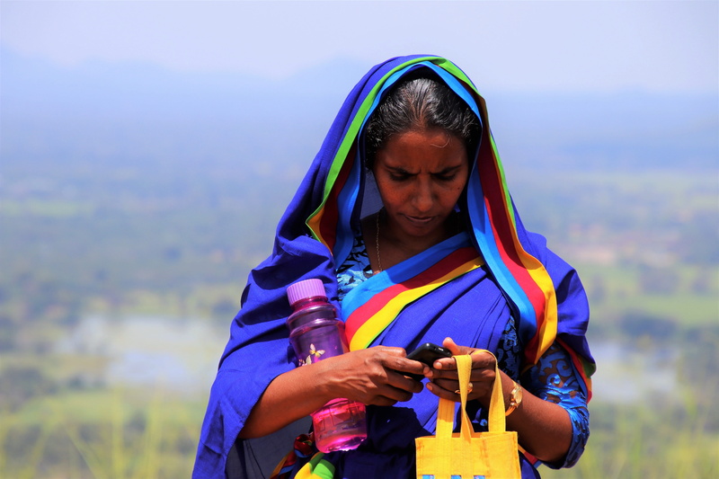 wireless technology, holiday, hood - clothing, girl, spirituality, sit, face, young adult, sari, mobile phone, youth, one person, phone, portrait of a woman