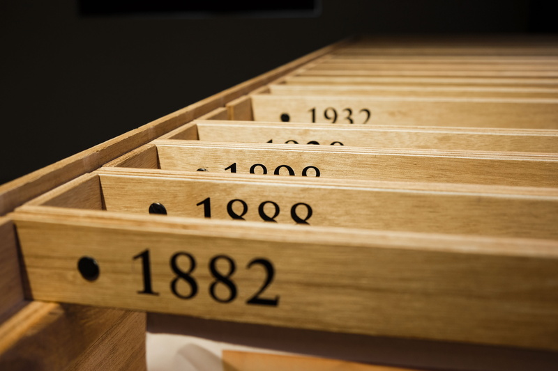 filing cabinet, arrangement, western script, closeup, studio shot, selective focus, photography, organization, in a row, yearly, number, business, black background
