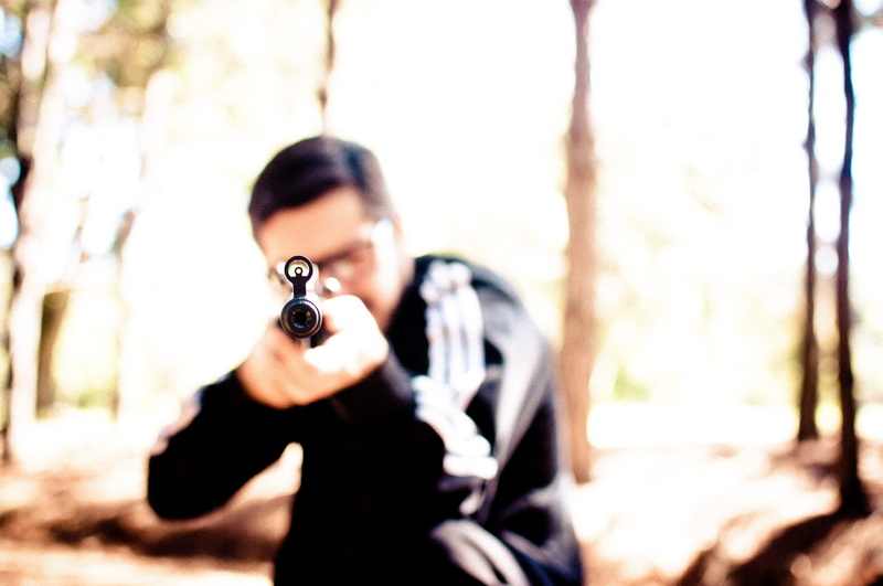 man, handgun, waist up, aiming, outdoors, pneumatic, one person, adult, portrait, holding, hunting, rifle, tree, day, carbine, aggression, nature, looking at camera