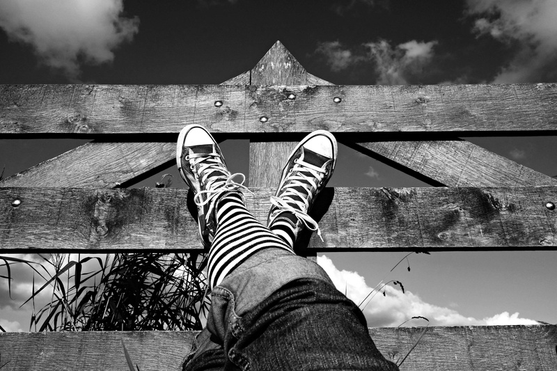 stripes, relaxation, low section, body part, style, architecture, black and white, leisure activity, shoe, relaxing, outdoors, wood, nature, jeans, lifestyles