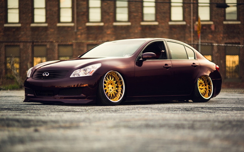 wheel, g, metal, sign, car, sedan, black, city, motor vehicle, street, tire, gx, parking, sports car, personal land vehicle, mode of transportation, no people