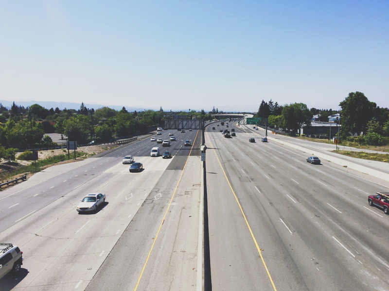sign, 2601 n shoreline blvd, car, high angle view, marking, united states, tree, nature, plant, symbol, mountain view, sky, multiple lane highway, day