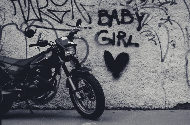 text, street, vehicle, emotion, wall, mode of transportation, wheel, spoke, land vehicle, outdoors, graffiti, motorcycle, art and craft, no people, 2K