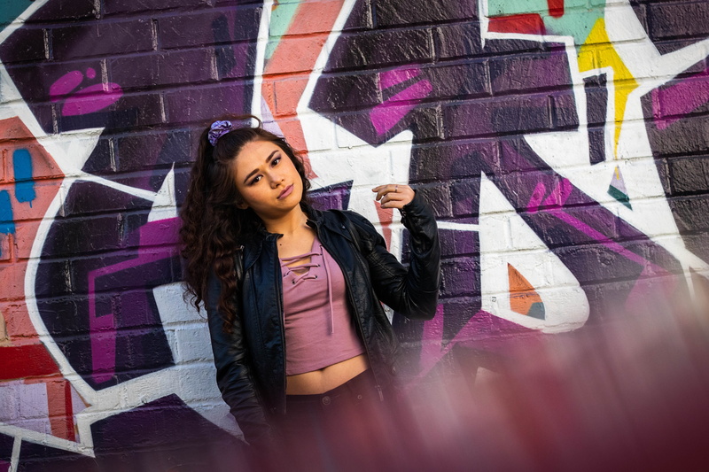 leather jacket, architecture, person, beautiful woman, contemplation, multi colored, art and craft, apparel, denim, female, graffiti, art, one person, women