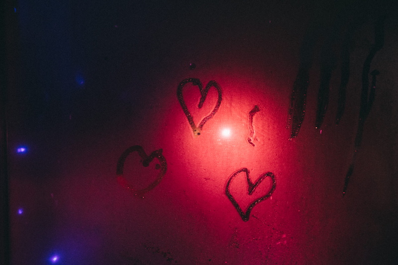 close-up, symbol, calligraphy, emotion, graffiti, indoors, illuminated, dance pose, wall - building feature, text, tattoo, glowing, heart, art and craft