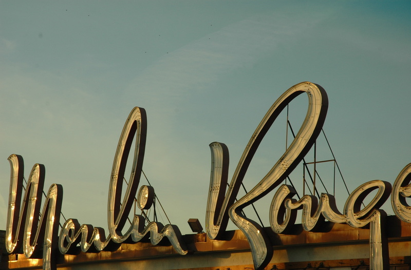 western script, sculpture, clear sky, moulin, built structure, architecture, day, 2K, Vintage, low angle view, sky, water, text, no people, design, Moulin Rouge